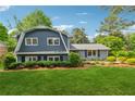 Beautiful home showcasing a well-manicured lawn, mature trees, and picturesque landscaping at 3772 Evans Rd, Atlanta, GA 30340