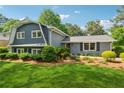 Two-story home exhibits mature landscaping, lawn, and a charming exterior at 3772 Evans Rd, Atlanta, GA 30340
