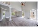 Spacious living room with tall ceilings, large windows, and plush carpeting at 1523 Fallen Leaf Dr, Marietta, GA 30064