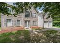 Two-story home with an attached two car garage and a beautifully landscaped front yard at 1528 Rogers Crossing Dr, Lithonia, GA 30058