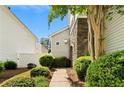 Beautiful exterior featuring a stone accent and lush landscaping around a sidewalk at 202 Windcroft Nw Ct, Acworth, GA 30101