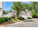 Charming two-story home with attached two-car garage, stone accent and lush landscaping at 202 Windcroft Nw Ct, Acworth, GA 30101