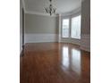Spacious living room with hardwood floors, detailed trim, and bright windows at 6121 Joybrook Rd, Johns Creek, GA 30097