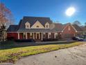 Expansive two-story brick home with a three-car garage and well-maintained landscaping at 3212 Woodhaven Sw Ct, Conyers, GA 30094