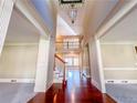 Grand two-story foyer with gleaming hardwood floors and classic architectural details at 3212 Woodhaven Sw Ct, Conyers, GA 30094