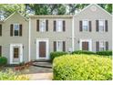 Inviting townhome featuring neutral siding, dark shutters, and manicured shrubs at 3407 Spring Harbour Dr # 2, Doraville, GA 30340