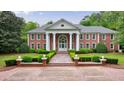 Elegant brick house showcases manicured landscaping and a symmetrical facade at 4500 Candacraig, Alpharetta, GA 30022