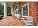 Inviting brick porch with seating area and elegant architectural details at 4500 Candacraig, Alpharetta, GA 30022