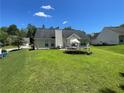 Large back yard with a well-manicured lawn and mature trees offering ample space at 2436 Moultrie Ct, Dacula, GA 30019