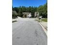 Peaceful residential street view showcasing well-maintained homes and lush greenery at 2436 Moultrie Ct, Dacula, GA 30019