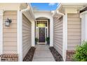 Inviting front entryway with detailed trim, updated door, and attractive landscaping at 352 Southgate Dr, Locust Grove, GA 30248