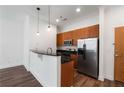 Modern kitchen with stainless steel appliances, granite countertops, wood cabinets, and stylish pendant lighting at 384 Ralph Mcgill Ne Blvd # 318, Atlanta, GA 30312