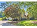 Brick house with an attached garage and mature trees in the front yard at 595 Mcgarity Dr, Mcdonough, GA 30252