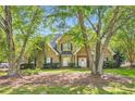 Beautiful brick home with lush green lawn framed by mature trees, offering a serene setting at 595 Mcgarity Dr, Mcdonough, GA 30252