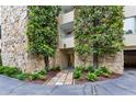 Stone facade and lush landscaping at Building B entrance, creating a welcoming approach at 2632 Peachtree Nw Rd # 203B, Atlanta, GA 30305
