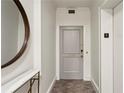 Hallway leading to unit 203 with a round mirror and marble shelf to complement the space at 2632 Peachtree Nw Rd # 203B, Atlanta, GA 30305