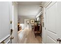Bright hallway view showcasing hardwood floors, leading to a stylishly decorated living space at 2632 Peachtree Nw Rd # 203B, Atlanta, GA 30305
