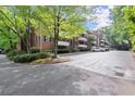 Apartment building exterior with manicured landscaping, ample parking, and mature trees at 305 Ridley Howard Ct, Decatur, GA 30030