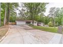 Charming single-story home featuring a lush front yard, attached two-car garage, and extra long driveway at 4100 Springlake Cir, Buford, GA 30519