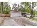 Charming single-story home featuring a lush front yard, attached two-car garage, and extra long driveway at 4100 Springlake Cir, Buford, GA 30519