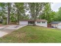 Charming single-story home featuring a lush front yard, attached two-car garage, and inviting front porch at 4100 Springlake Cir, Buford, GA 30519