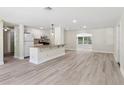 Open concept kitchen with white cabinets, granite countertops, and stainless steel appliances at 1030 Brockdell Ct, Norcross, GA 30093