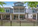 A fenced backyard with patio and balcony provides plenty of outdoor living space at 1110 Harper Dr, Roswell, GA 30076