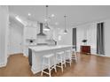 Modern kitchen with stainless steel appliances and a large center island with bar stool seating at 1110 Harper Dr, Roswell, GA 30076
