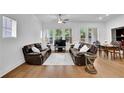 Bright living room features hardwood floors, large windows, and comfortable seating at 1110 Harper Dr, Roswell, GA 30076