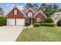Charming red brick home with a well-manicured lawn and a two-car garage at 1250 Parkview Nw Ln, Kennesaw, GA 30152
