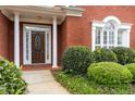 Elegant brick home with a decorative front door and manicured landscaping at 1250 Parkview Nw Ln, Kennesaw, GA 30152
