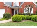 Red brick home adorned with manicured greenery and a well-maintained lawn at 1250 Parkview Nw Ln, Kennesaw, GA 30152