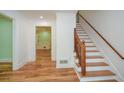 Entry hall with hardwood floors, a staircase, and a view of the dining room at 1508 Walker Ridge Sw Dr, Marietta, GA 30064