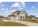 The two car garage and wide drive are displayed at 321 Arwen Dr, Mcdonough, GA 30252