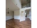 Bright living room featuring hardwood floors, fresh paint, and a chandelier with easy access to the second story at 1474 Union Station, Lawrenceville, GA 30045