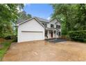 Charming two-story home with white siding, black shutters, red front door, and a well-manicured lawn at 1620 Bluewater Ct, Cumming, GA 30041