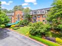 Stately brick apartment building with mature landscaping, manicured lawn, and convenient parking area at 28305 Plantation Ne Dr, Atlanta, GA 30324
