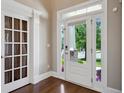 Bright foyer featuring hardwood floors, a glass front door, and a view of the front yard at 3909 Obryant Se Cir, Smyrna, GA 30082