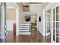 Elegant foyer with gleaming hardwood floors, staircase, and view into other rooms at 3909 Obryant Se Cir, Smyrna, GA 30082
