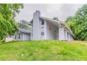 Two-story home with a chimney and multiple large windows at 6255 Saddlewood Dr, Lithonia, GA 30058