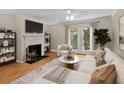 Cozy living room features fireplace, TV, modern furniture, and bright light at 3486 Essex Ave # 88, Atlanta, GA 30339