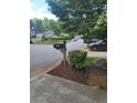 View of the mailbox and road showing the beautiful landscaping that adds to the neighborhood's charm at 4157 Lake Mist Nw Dr, Kennesaw, GA 30144