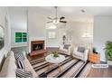 Cozy living room features a fireplace, ceiling fan, and neutral decor at 541 Mckenzie Ave, Stockbridge, GA 30281