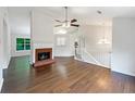 Bright living room with wood flooring, fireplace, and a view into the kitchen at 541 Mckenzie Ave, Stockbridge, GA 30281