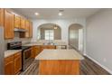 Bright kitchen boasts granite counters, stainless appliances, and a convenient center island at 6053 Park Close, Fairburn, GA 30213