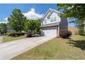 A beautiful two-story home with a well-maintained lawn and landscaping at 2341 Lily Valley Dr, Lawrenceville, GA 30045