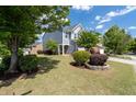 This two-story home features charming landscaping and well-manicured lawn at 2341 Lily Valley Dr, Lawrenceville, GA 30045