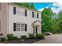 Traditional two-story townhome with black shutters, covered entry, and manicured shrubs at 285 Enterprise Path, Hiram, GA 30141