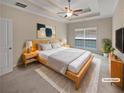 Cozy bedroom with a tray ceiling, ceiling fan, and a comfortable queen-sized bed at 403 Vinings Vintage Cir, Mableton, GA 30126
