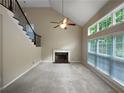 Open living room features high ceilings, a fireplace, and large windows for natural light at 403 Vinings Vintage Cir, Mableton, GA 30126